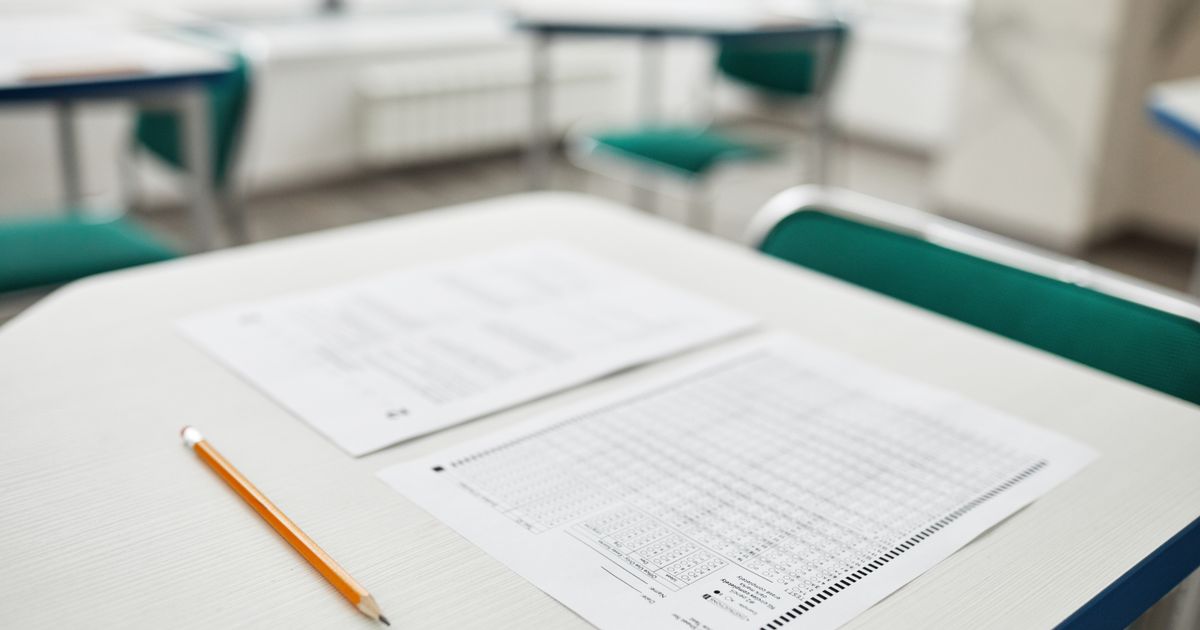 An exam paper and a pencil on a desk, ready to be worked through